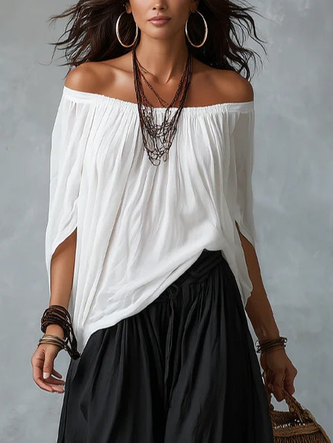 White off-shoulder top and flared lantern-style pants