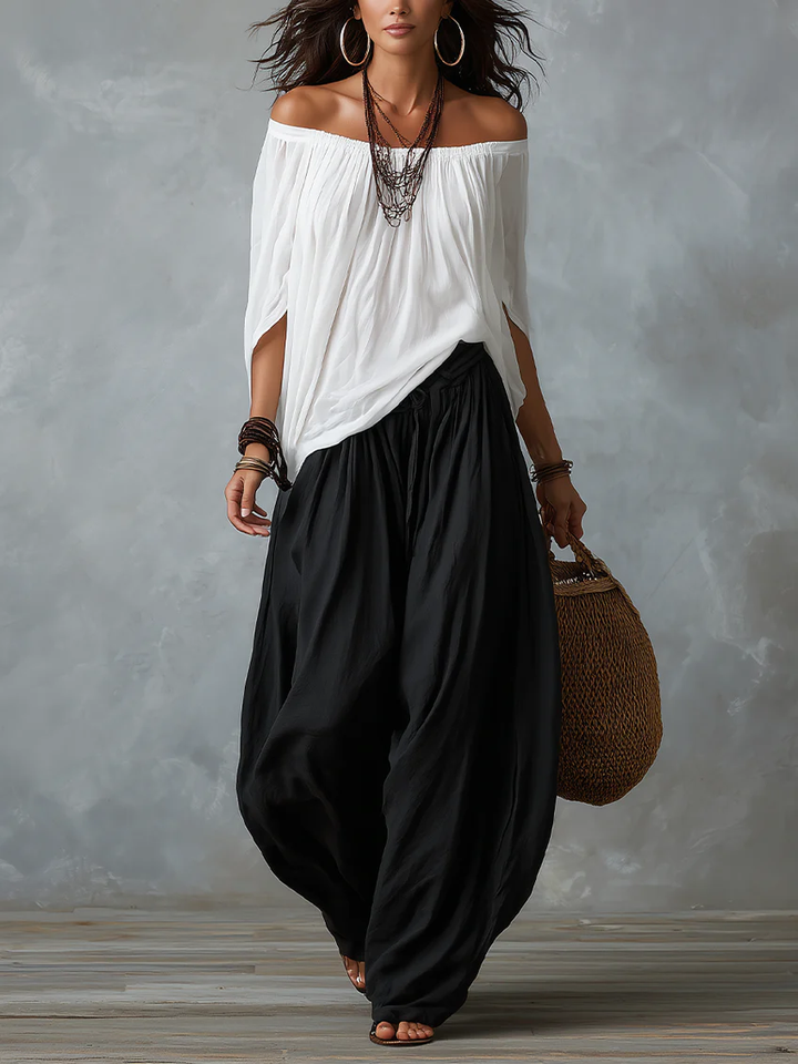 White off-shoulder top and flared lantern-style pants